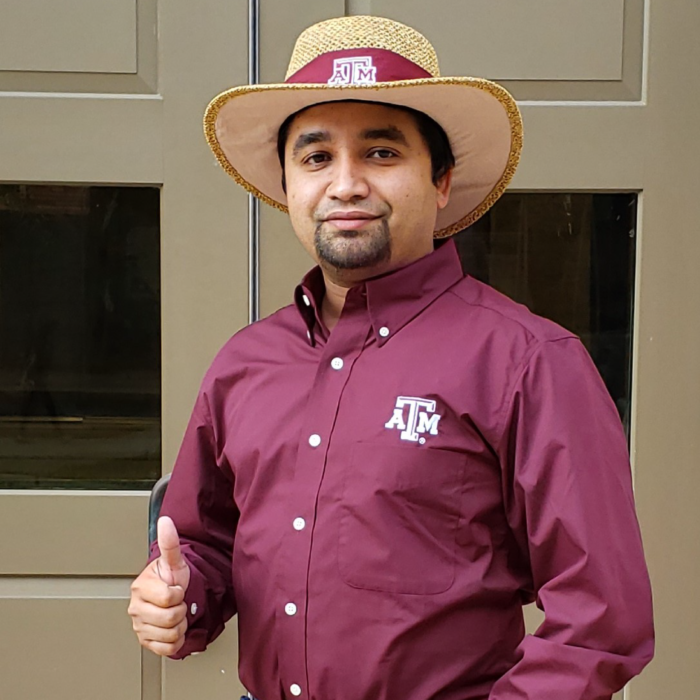 Photo of A&M Student giving Gig 'em sign
